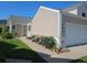 Home exterior featuring a two-car garage, vibrant flower bed, and well-kept lawn at 535 High Point Dr, Golden, CO 80403