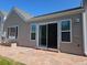 Home exterior featuring a stone patio and a sliding glass door at 535 High Point Dr, Golden, CO 80403