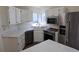 Modern kitchen with stainless steel appliances, white cabinets, and a central island for added workspace at 535 High Point Dr, Golden, CO 80403
