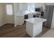 Well-equipped kitchen featuring white cabinets, stainless steel appliances, and an island with seating at 535 High Point Dr, Golden, CO 80403