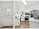 Bright kitchen with stainless steel appliances, stylish lighting and tile backsplash at 535 High Point Dr, Golden, CO 80403