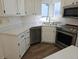 Bright kitchen with white cabinets, stainless steel appliances, and modern countertops at 535 High Point Dr, Golden, CO 80403