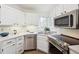 Modern kitchen with stainless steel appliances and white cabinets at 535 High Point Dr, Golden, CO 80403