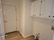 Laundry room boasting white cabinets, a side-by-side washer and dryer hookups, and wood-look flooring at 535 High Point Dr, Golden, CO 80403
