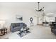 Bright living room featuring vaulted ceilings and open floor plan to the kitchen with bar seating at 535 High Point Dr, Golden, CO 80403