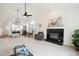Bright open living room featuring a fireplace, arched window, and adjacent kitchen at 535 High Point Dr, Golden, CO 80403