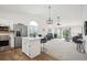 Open floor plan with modern kitchen island and living room at 535 High Point Dr, Golden, CO 80403