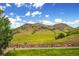 Scenic view of rolling hills and a vibrant blue sky with scattered clouds at 535 High Point Dr, Golden, CO 80403
