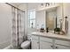 Well-lit bathroom featuring a shower/tub combo, white cabinets, and attractive fixtures at 8733 Arriba Dr, Littleton, CO 80125