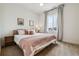 Bright bedroom with a large window providing natural light and plush carpet flooring at 8733 Arriba Dr, Littleton, CO 80125