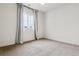 Empty bedroom featuring a ceiling fan, carpet flooring and natural light from the window at 8733 Arriba Dr, Littleton, CO 80125