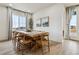 Bright dining room features a large wood table, perfect for gatherings and everyday meals at 8733 Arriba Dr, Littleton, CO 80125