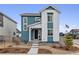Charming two-story home features blue and white siding, landscaped front yard, and inviting entryway at 8733 Arriba Dr, Littleton, CO 80125