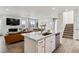 Spacious kitchen with island, seamlessly integrates with the living and dining areas for open-concept living at 8733 Arriba Dr, Littleton, CO 80125
