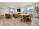 Open-concept living room with hardwood floors, a fireplace, and stylish modern furnishings at 8733 Arriba Dr, Littleton, CO 80125