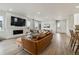 Spacious living room with stylish leather seating, fireplace, and open layout perfect for entertaining at 8733 Arriba Dr, Littleton, CO 80125