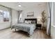 Comfortable main bedroom featuring large window with curtains, ceiling fan and nice decor at 8733 Arriba Dr, Littleton, CO 80125