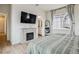 Comfortable main bedroom with a decorative fireplace and large window for natural light at 8733 Arriba Dr, Littleton, CO 80125