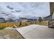 Concrete backyard patio with stone landscaping and a wood fence at 15376 Ivanhoe Ct, Thornton, CO 80602