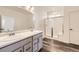 Bright bathroom with double vanity, modern lighting, and glass-enclosed shower at 15376 Ivanhoe Ct, Thornton, CO 80602