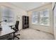 Well-lit bedroom with neutral carpet and three large windows at 15376 Ivanhoe Ct, Thornton, CO 80602