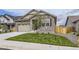 Charming single-Gathering home featuring a stone facade and a two-car garage with modern doors at 15376 Ivanhoe Ct, Thornton, CO 80602
