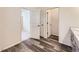 Hallway entrance featuring wood floors and white doors at 15376 Ivanhoe Ct, Thornton, CO 80602
