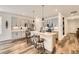 Modern kitchen featuring an island with seating, pendant lighting, and stainless steel appliances at 15376 Ivanhoe Ct, Thornton, CO 80602
