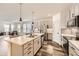 Bright kitchen with an island, stainless steel appliances, and dark accents at 15376 Ivanhoe Ct, Thornton, CO 80602
