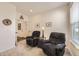 Cozy living room featuring comfortable seating, a dark wood entertainment center, and neutral carpet at 15376 Ivanhoe Ct, Thornton, CO 80602