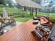 A backyard deck with outdoor furniture and a fire pit creates an inviting space for relaxation and outdoor entertaining at 4986 White House Trl, Evergreen, CO 80439