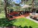 A backyard deck with outdoor furniture and a green lawn creates an inviting space for relaxation and outdoor entertaining at 4986 White House Trl, Evergreen, CO 80439