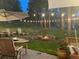 An inviting backyard firepit, stone retaining wall, and string lights create a perfect outdoor relaxation space at 4986 White House Trl, Evergreen, CO 80439