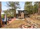 Backyard deck with outdoor seating, fire pit, stone chimney, and mountain views at 4986 White House Trl, Evergreen, CO 80439