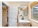 Bright bathroom with a floating vanity, framed mirror, and a window for natural light at 4986 White House Trl, Evergreen, CO 80439