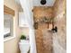 This bathroom features tiled walls, a shower with a rainfall shower head, and a window for natural light at 4986 White House Trl, Evergreen, CO 80439