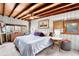 A cozy bedroom featuring a wood ceiling and an exterior window, creating a serene and inviting space at 4986 White House Trl, Evergreen, CO 80439