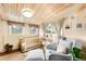 This Bedroom has a wood-paneled ceiling, a beige color scheme, and two large windows for natural light at 4986 White House Trl, Evergreen, CO 80439