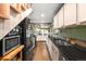 Galley kitchen with black granite countertops and white cabinets at 4986 White House Trl, Evergreen, CO 80439