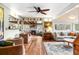 Open living room with hardwood floors, a wood-burning fireplace, and stylish decor at 4986 White House Trl, Evergreen, CO 80439