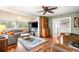 Bright, inviting living room with a wooden ceiling and view into the kitchen at 4986 White House Trl, Evergreen, CO 80439