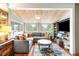 Cozy living room featuring wood ceiling, large windows, and a comfortable sectional sofa at 4986 White House Trl, Evergreen, CO 80439
