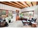 Relaxing sitting area features a comfortable chair, ottoman, and large windows with exterior views at 4986 White House Trl, Evergreen, CO 80439