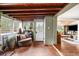 Cozy sun room featuring terracotta tile floor and exposed wood beam ceiling at 4986 White House Trl, Evergreen, CO 80439