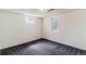 Finished basement room with carpet flooring and two windows at 16588 E 8Th Ave, Aurora, CO 80011