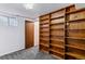 Basement featuring shelving, a door, and carpet flooring at 16588 E 8Th Ave, Aurora, CO 80011