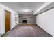 Spacious finished basement featuring a brick fireplace and built-in shelving at 16588 E 8Th Ave, Aurora, CO 80011