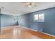 Large bedroom with hardwood floors, multiple windows, and a ceiling fan at 16588 E 8Th Ave, Aurora, CO 80011