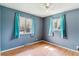 Inviting bedroom with hardwood floors, two windows, and a ceiling fan at 16588 E 8Th Ave, Aurora, CO 80011