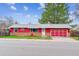 Charming ranch home with red siding, brick accents, and a convenient attached garage at 16588 E 8Th Ave, Aurora, CO 80011